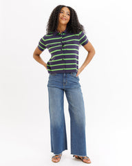 Woman wearing a striped shirt and jeans on a white background