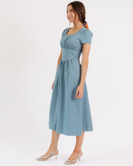 Woman wearing a blue dress on a white background