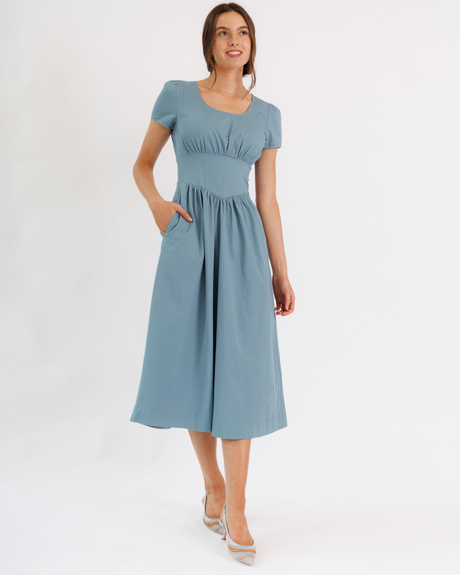 Woman wearing a light blue dress on a white background