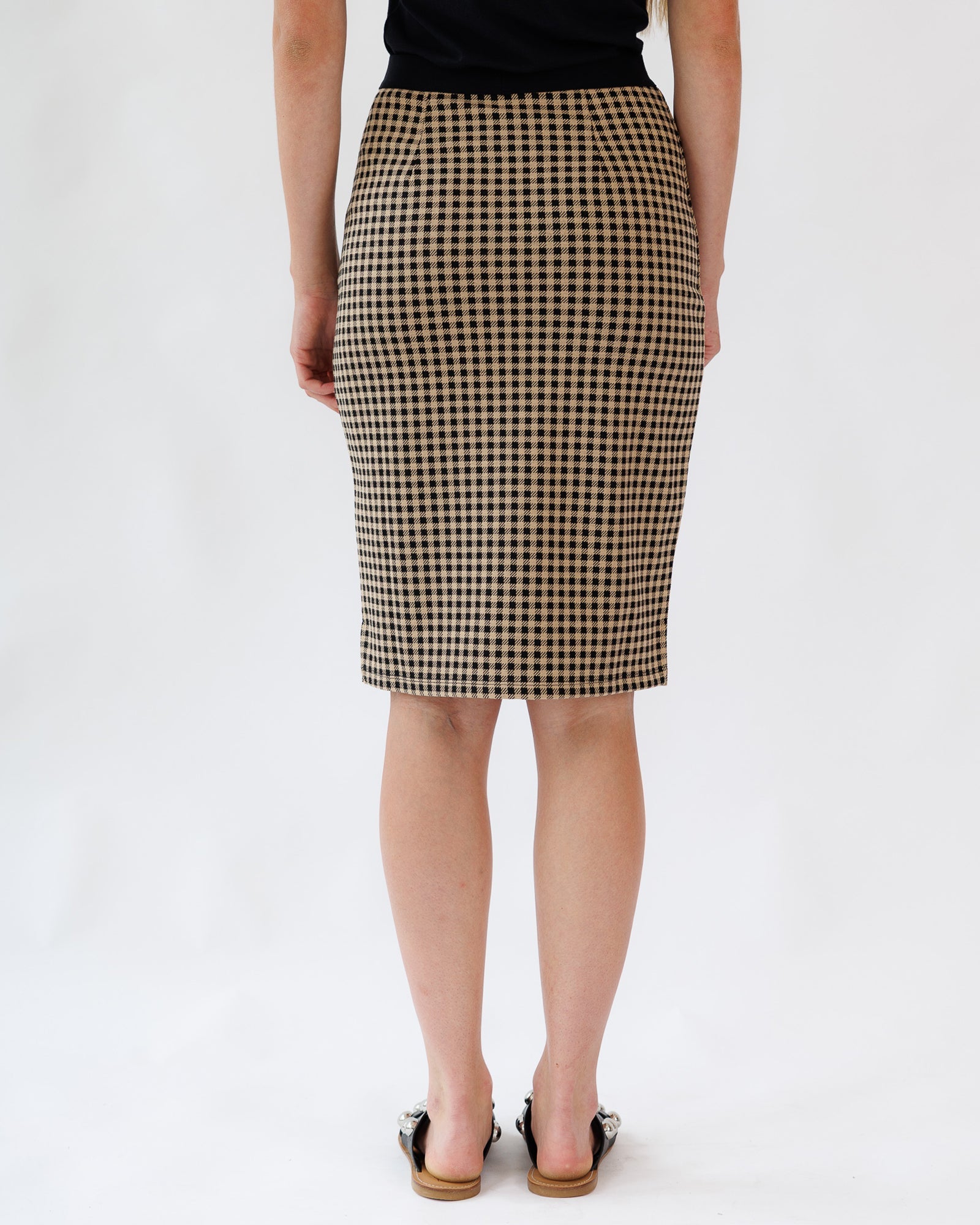 Person wearing a checkered skirt on a white background