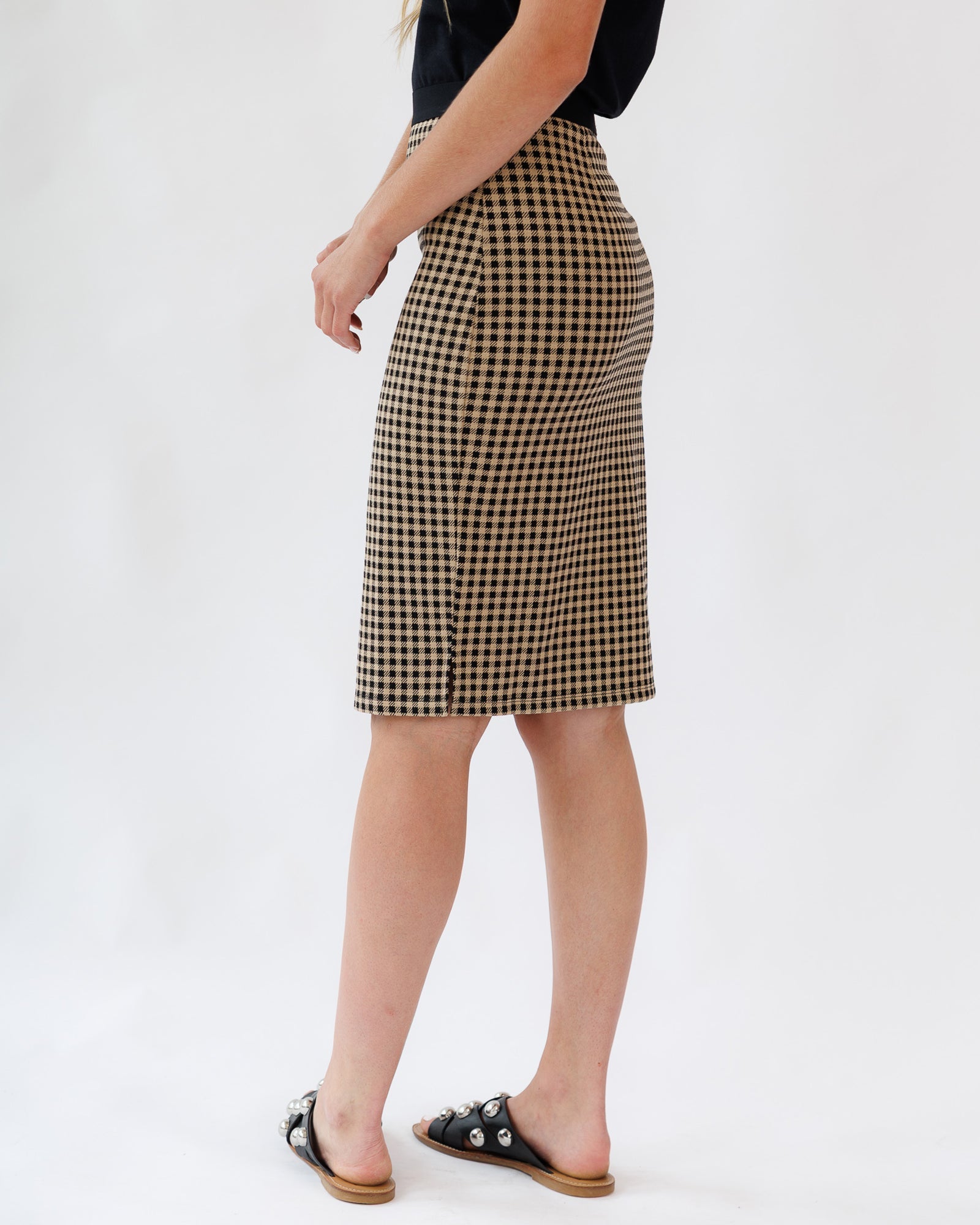 Person wearing a checkered skirt on a white background