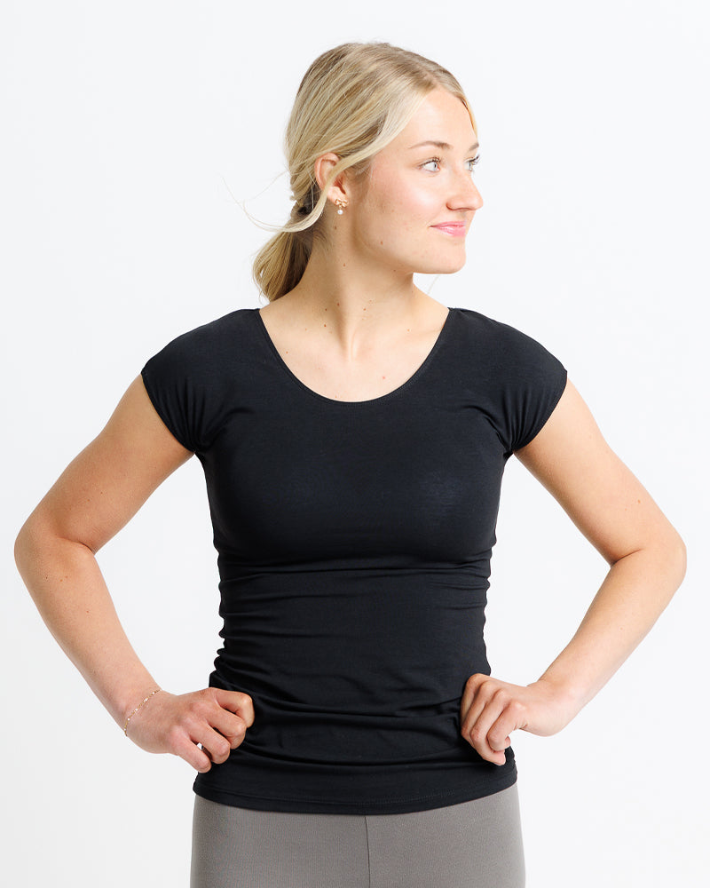 Woman wearing a black t-shirt against a white background