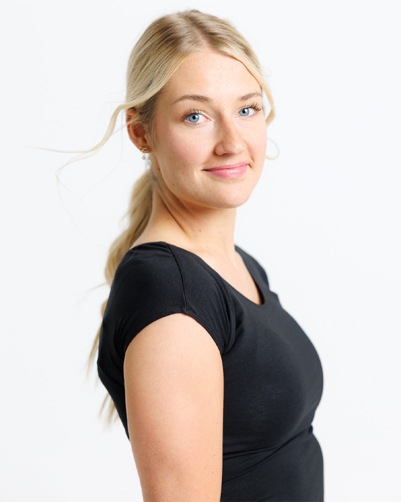 Woman wearing a black top against a white background