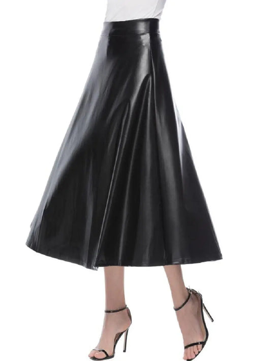 A person wearing a high-waisted brown PU leather long skirt with a flared design, paired with heels.