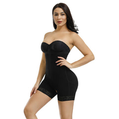 Woman wearing a black strapless bodysuit on a white background