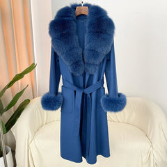 Blue coat with fur trim on a white chair