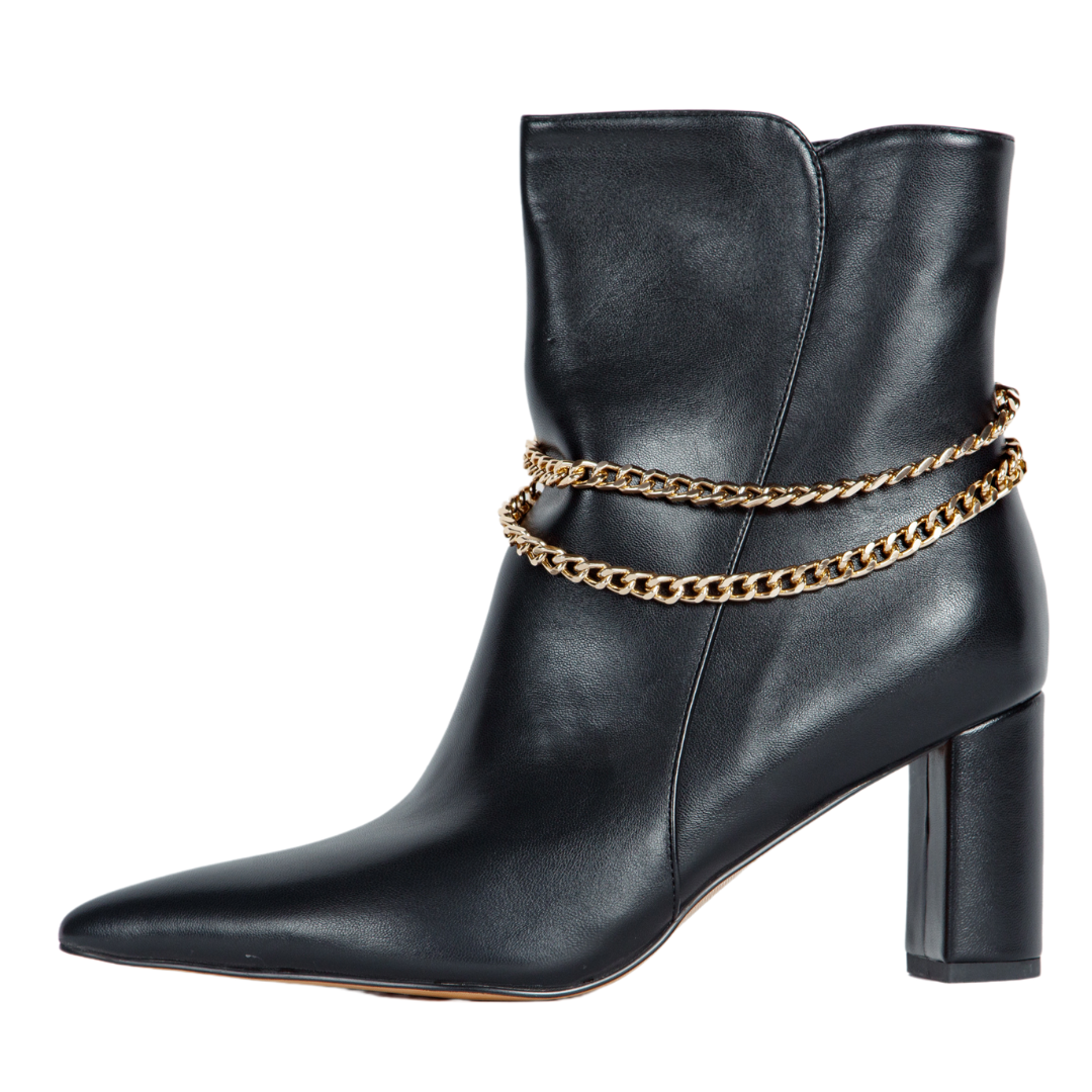 Black leather ankle boot with gold chain detail on a white background