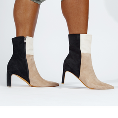 Black and beige ankle boots on a white background