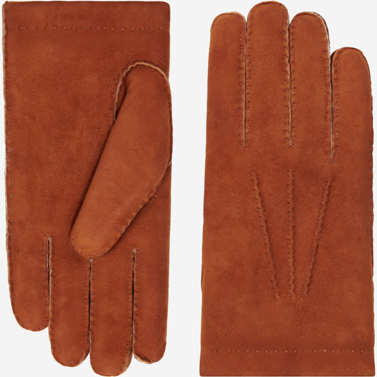 Pair of brown leather gloves on a white background