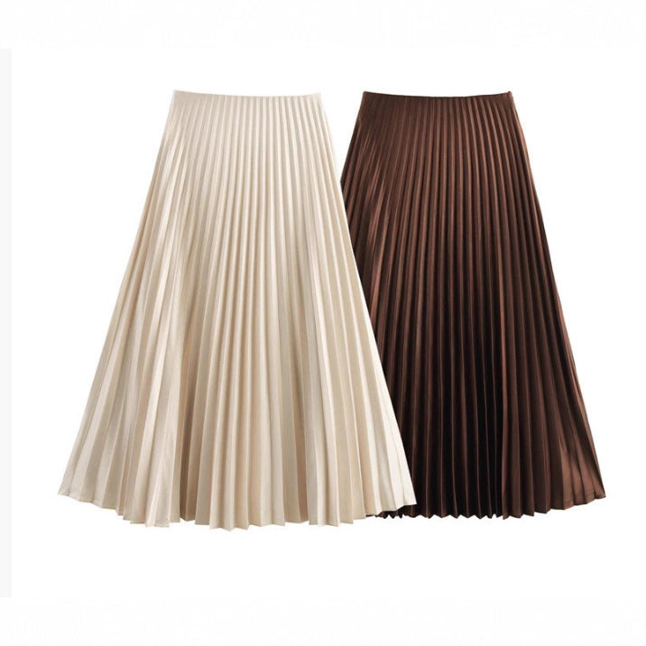Two pleated skirts, one beige and one brown, on a white background.
