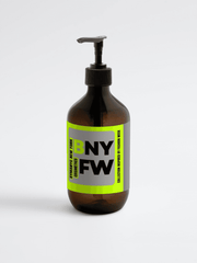 Brown bottle with a pump and a label on a light gray background