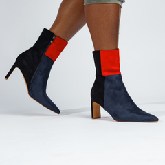 Navy blue and red ankle boots on a white background