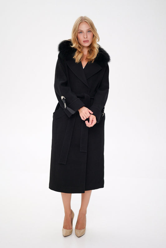 Woman wearing a black coat with fur trim on a white background