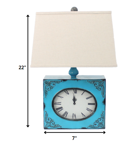 Table lamp with a metal base in the form of a clock