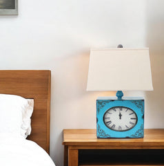 Table lamp with a metal base in the form of a clock