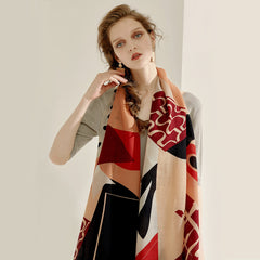 Woman wearing a patterned scarf on a plain background