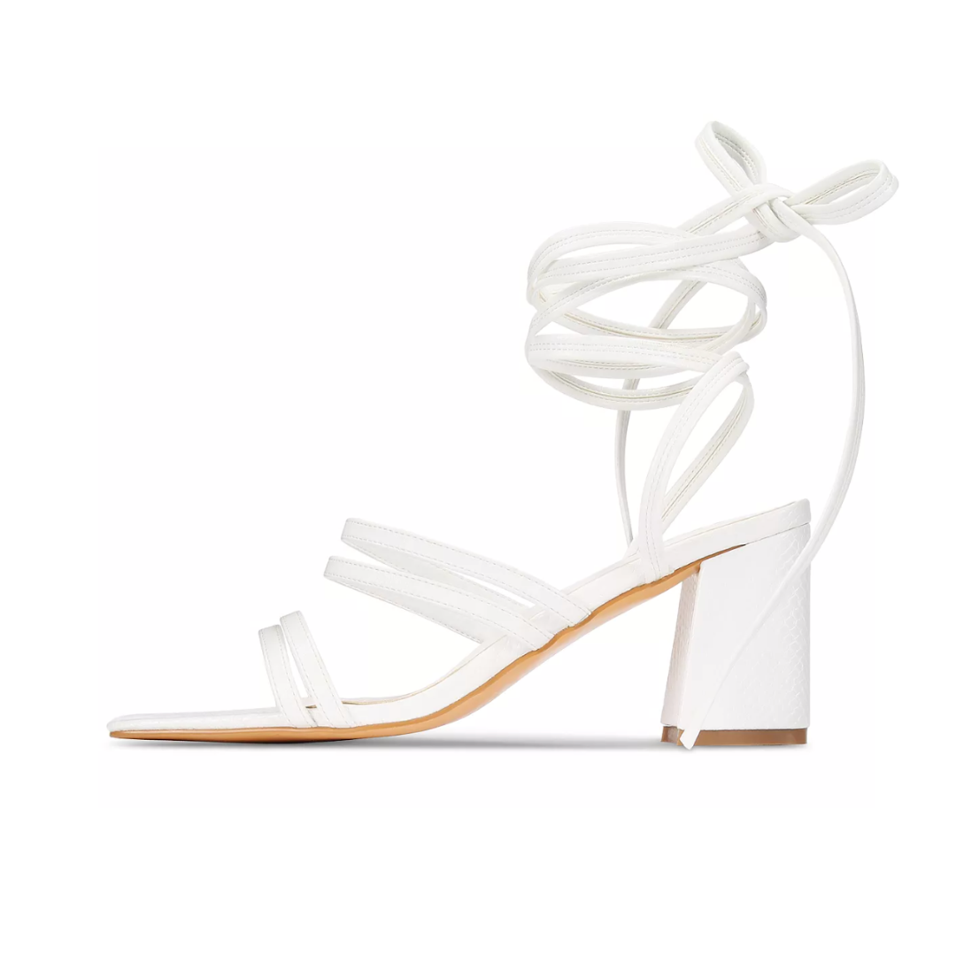 White sandal with ankle strap on a white background