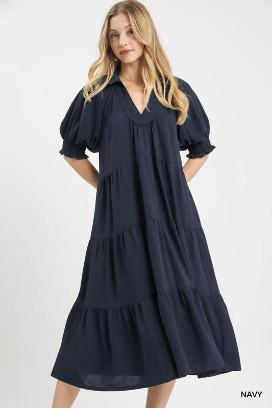 Woman wearing a navy blue dress on a white background