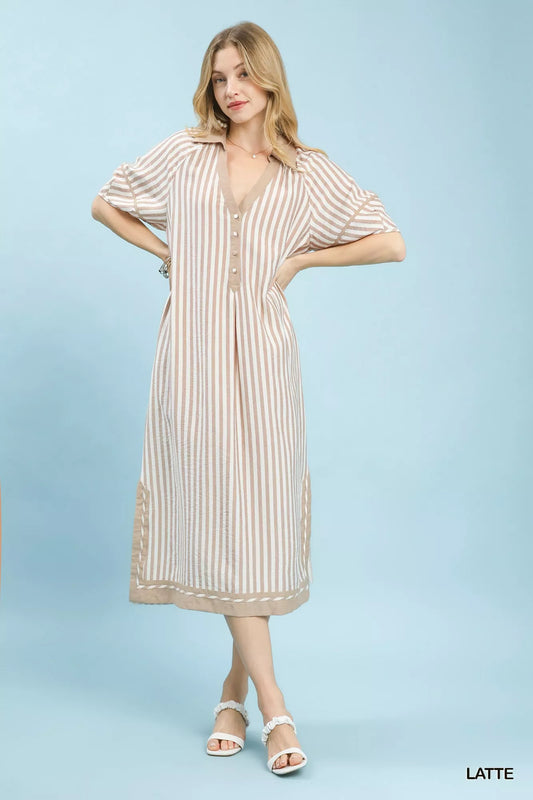 Woman wearing a striped dress on a light blue background