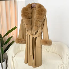Beige coat with fur trim hanging on a chair against a white wall.