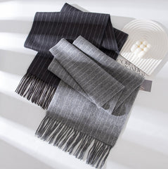 Gray scarf with fringe on a white surface