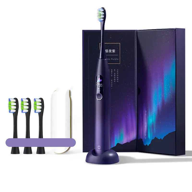 Purple electric toothbrush with packaging, brush heads, and a stand on a white background