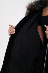 Black coat with fur hood on a white background