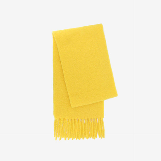 Yellow scarf with fringes on a light gray background