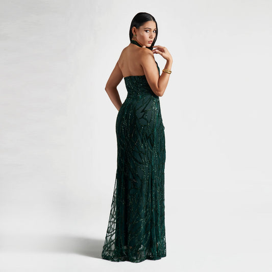 Woman wearing a green strapless dress against a white background