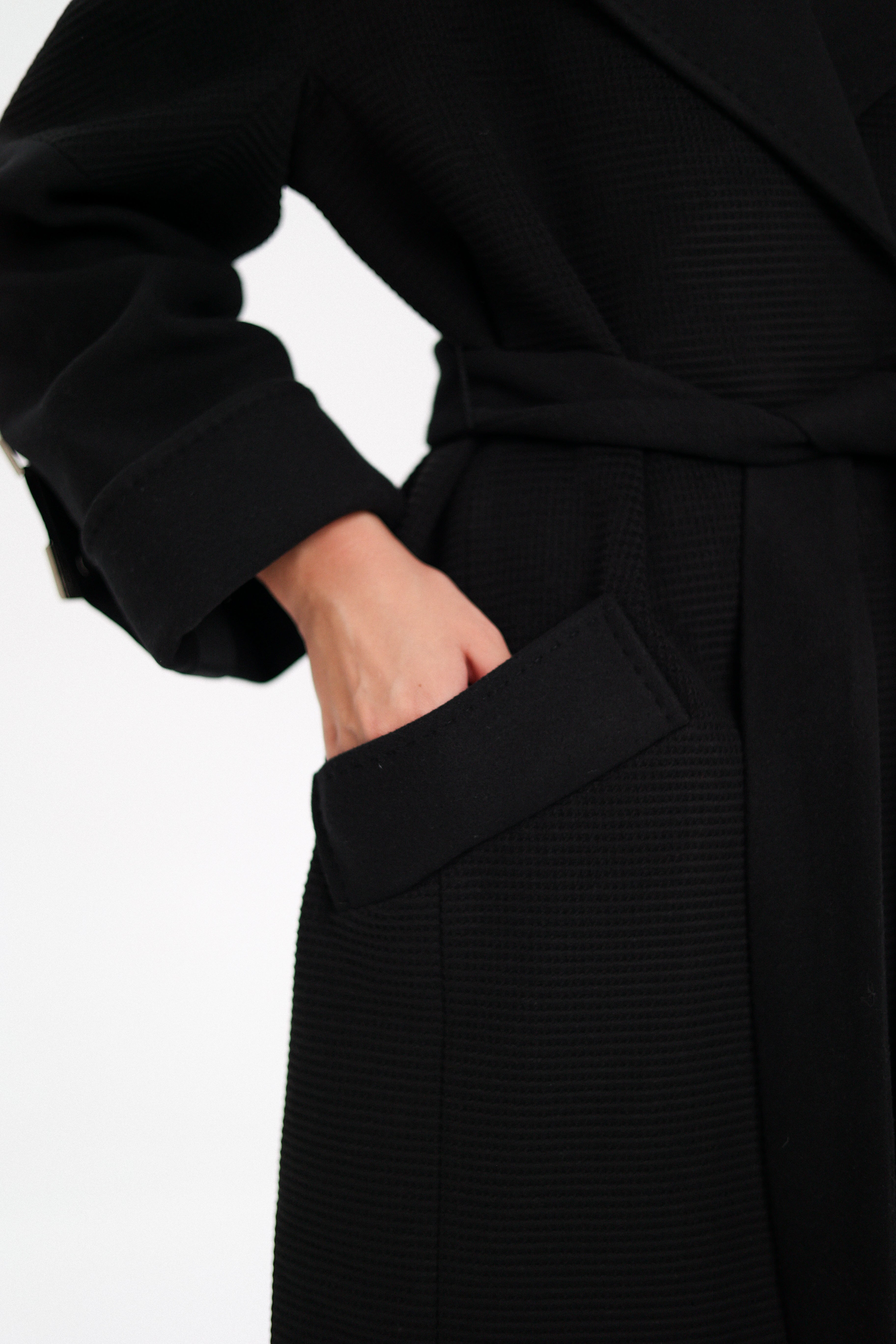 Black coat with a belt on a white background