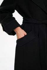 Black coat with a belt on a white background