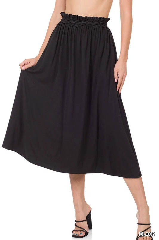 Black skirt worn by a person on a white background