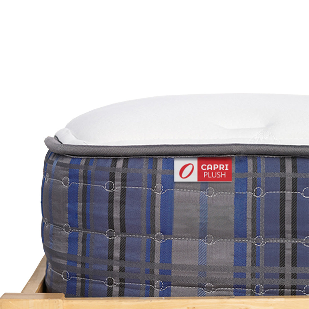 Mattress with plaid cover and 'Capri Plush' branding on a white background