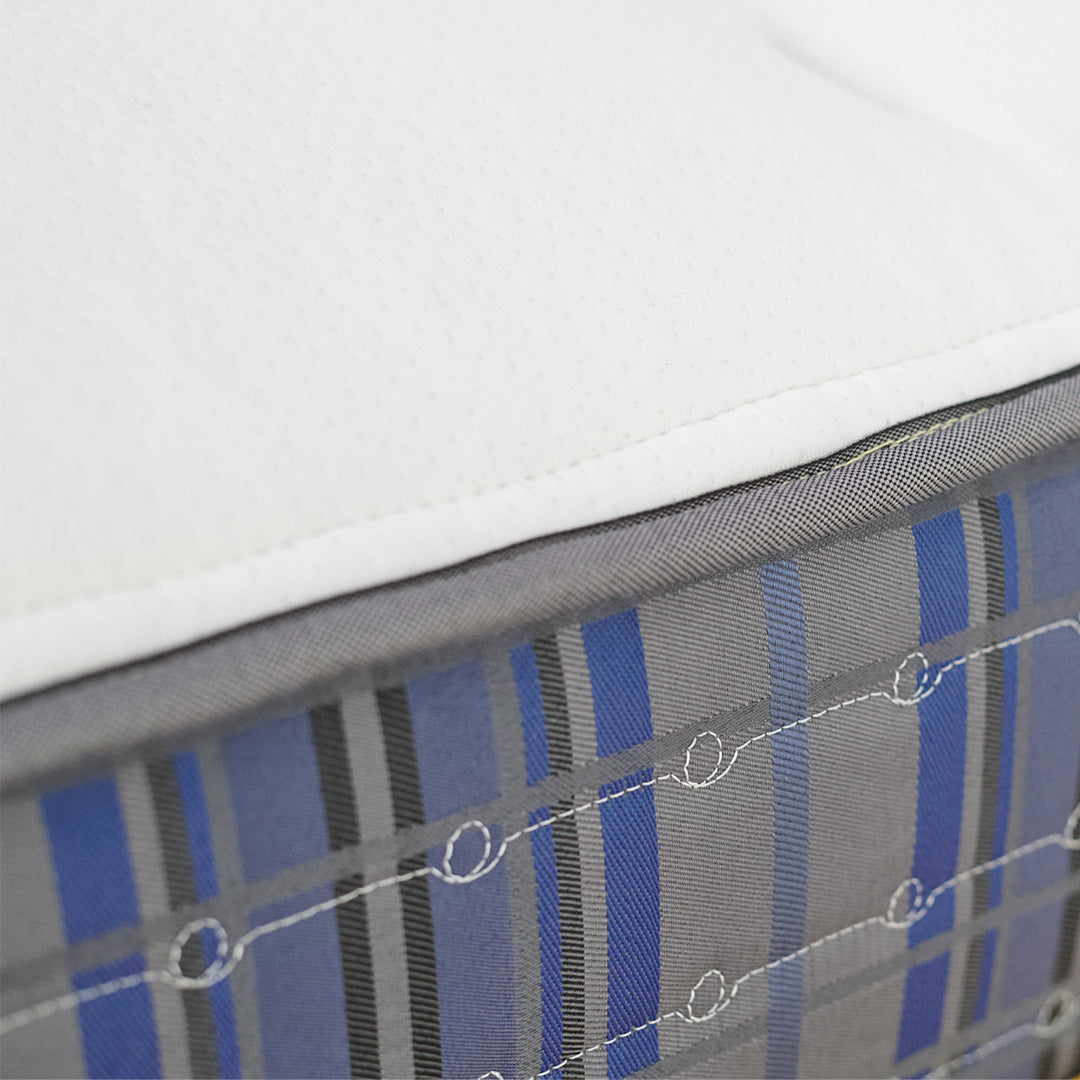 Close-up of a mattress with blue and gray striped pattern