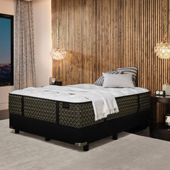 Black and white mattress in a bedroom setting with decorative elements.