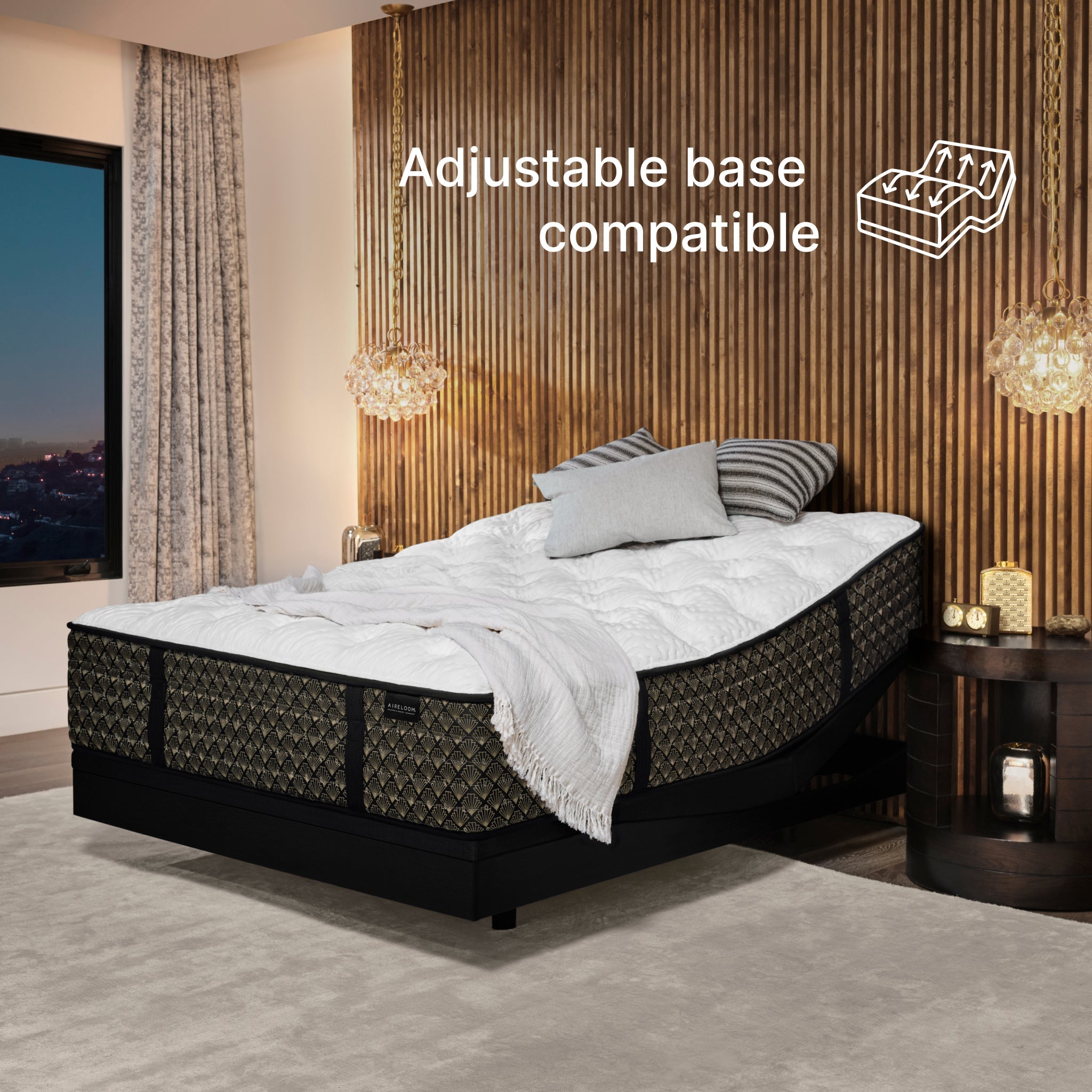Bed with adjustable base in a bedroom setting, featuring text 'Adjustable base compatible'.