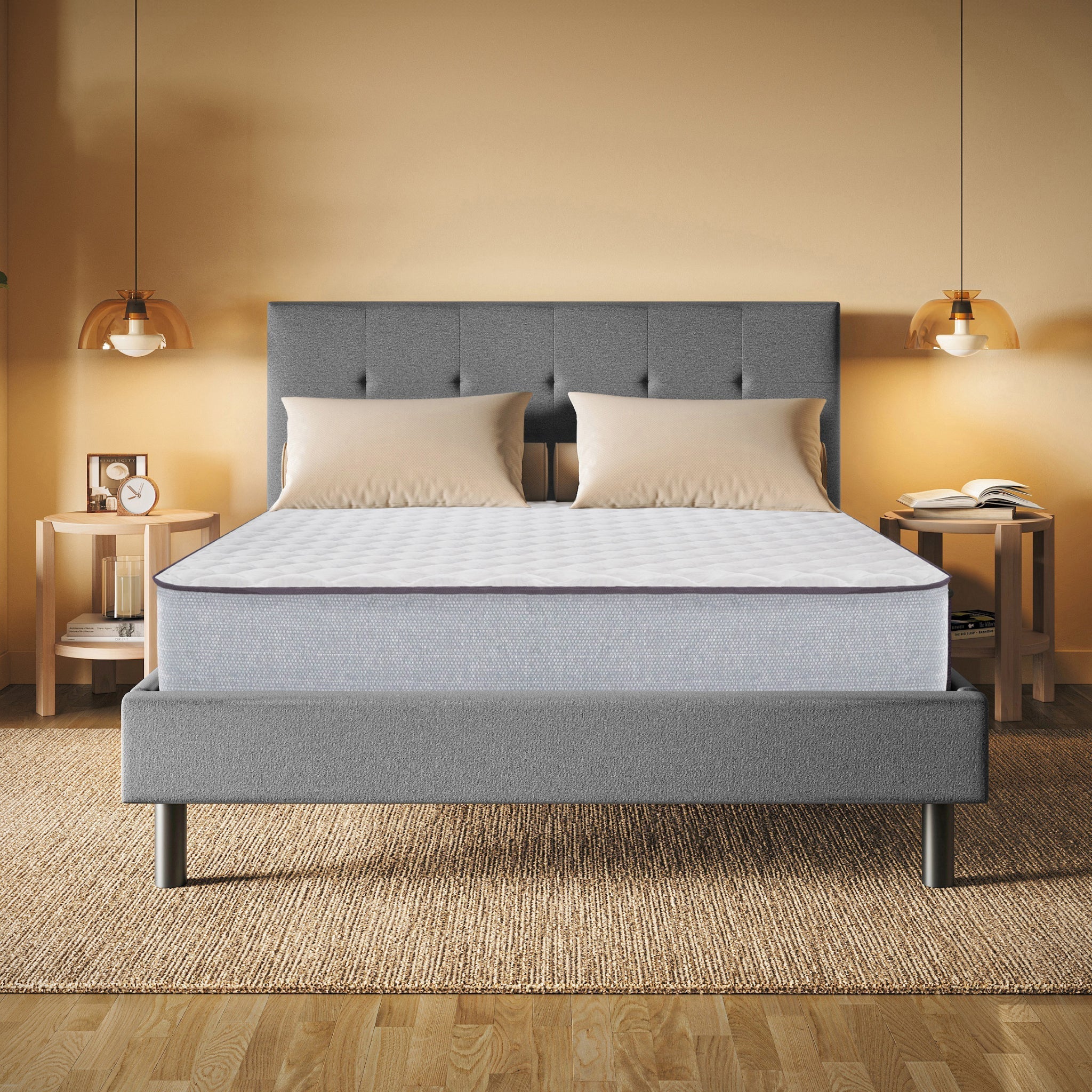 Gray upholstered bed with a mattress in a bedroom setting.