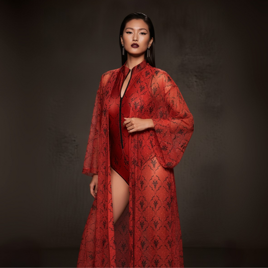 Woman wearing a red patterned robe against a dark background