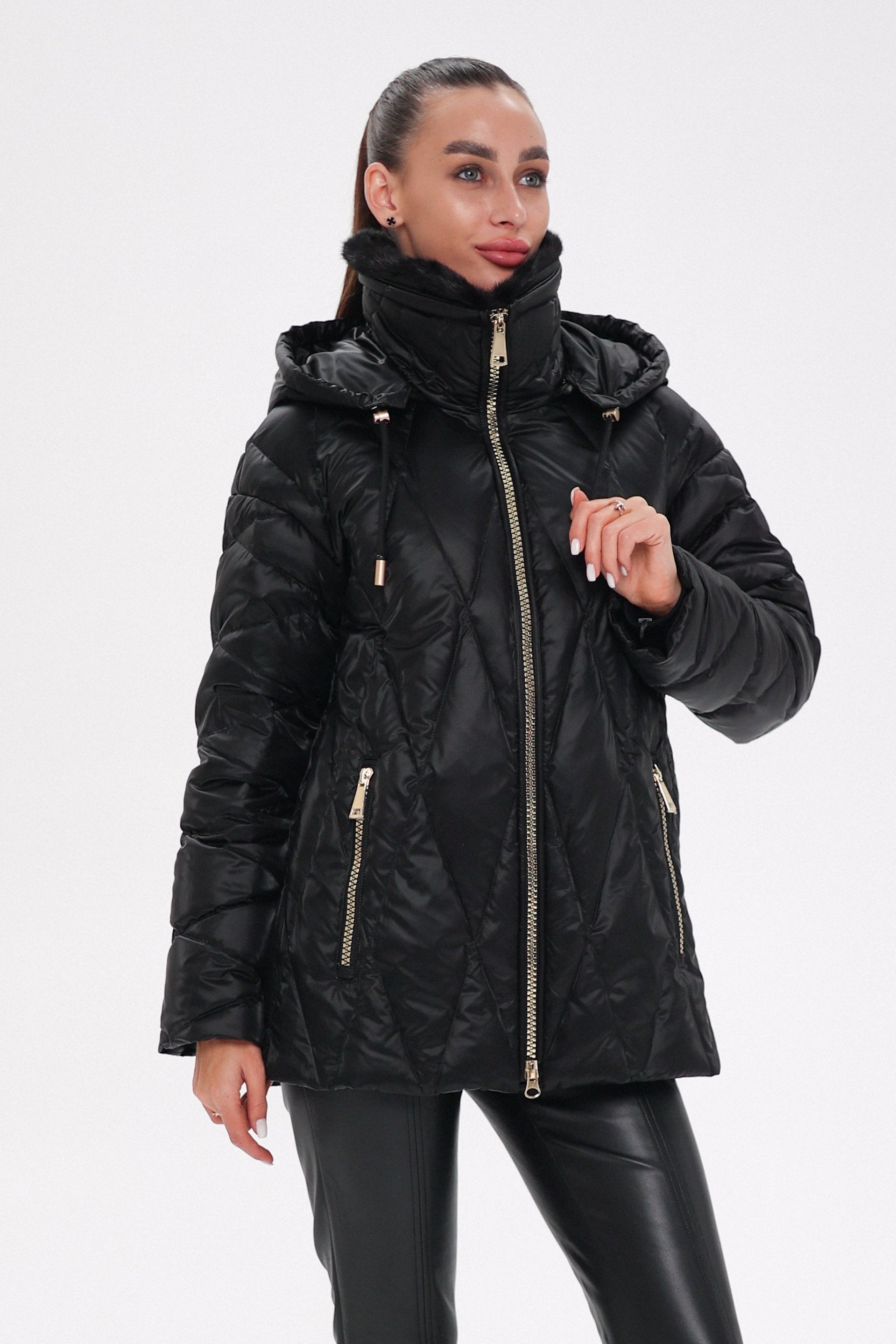 Close-up of a black coat with a silver buckle on a white background