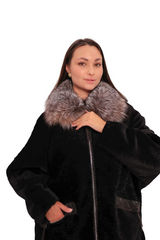 Woman wearing a black coat with fur collar on a white background