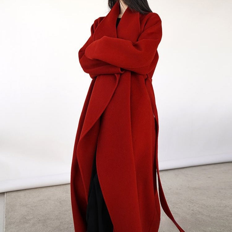 Red coat with a belt on a white background