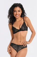 Woman wearing a black lace lingerie set on a white background