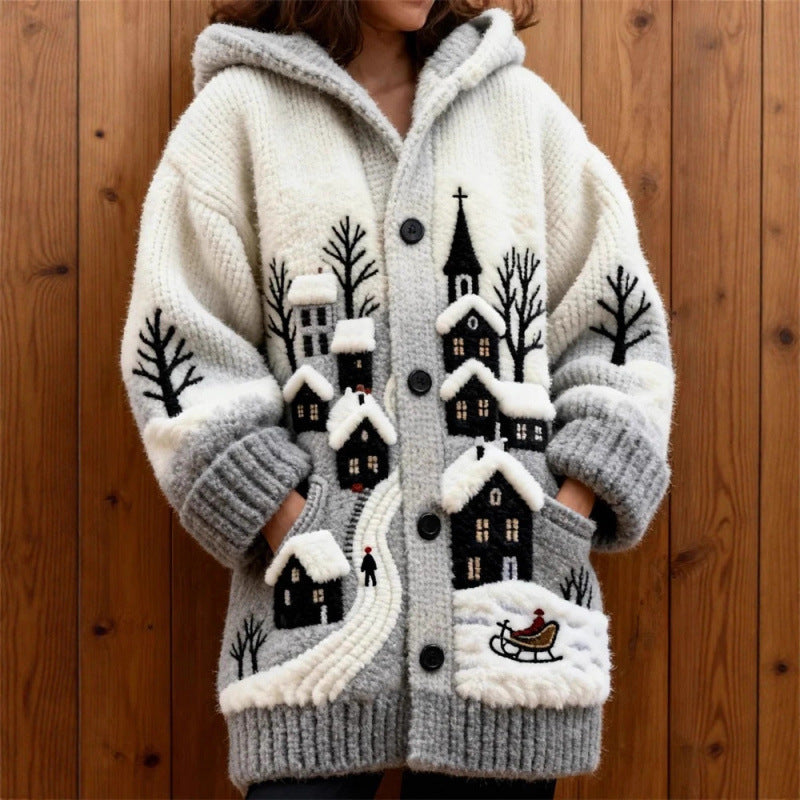 Knitted cardigan with winter scene design against a wooden background
