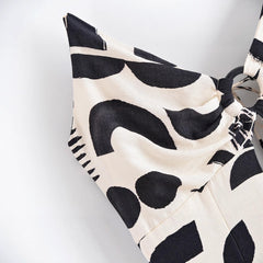 Black and white patterned bikini top on a light gray background