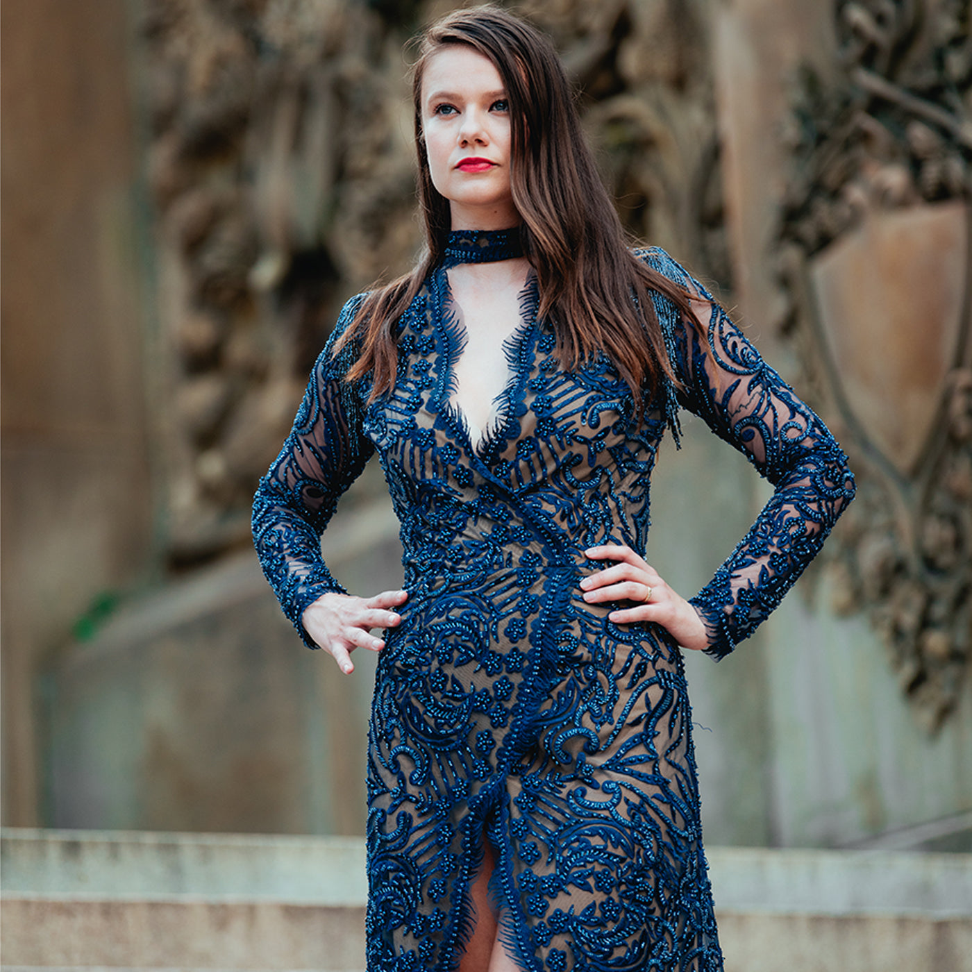 Woman wearing a blue lace dress with a blurred background
