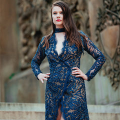 Woman wearing a blue lace dress with a blurred background