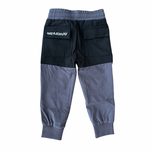 Black and gray pants with a brand logo on a white background