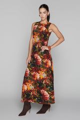 Woman wearing a sleeveless floral dress on a gray background