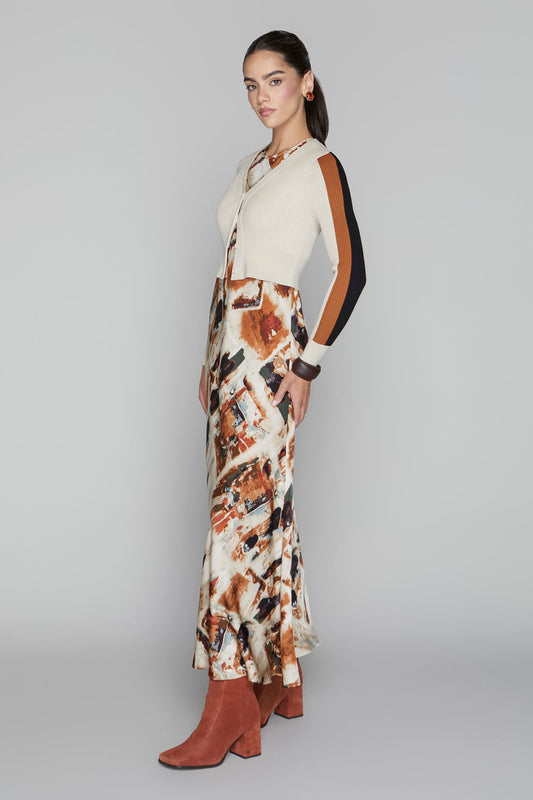 Woman wearing a patterned dress with a neutral background