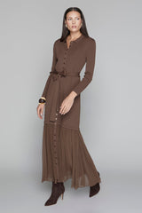 Woman wearing a brown dress with a belt on a gray background